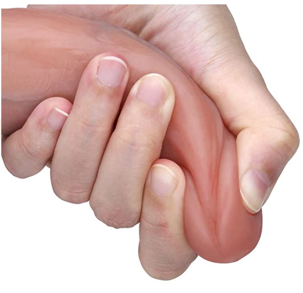 A hand holding a realistic, flesh-toned silicone dildo, demonstrating its flexibility and softness