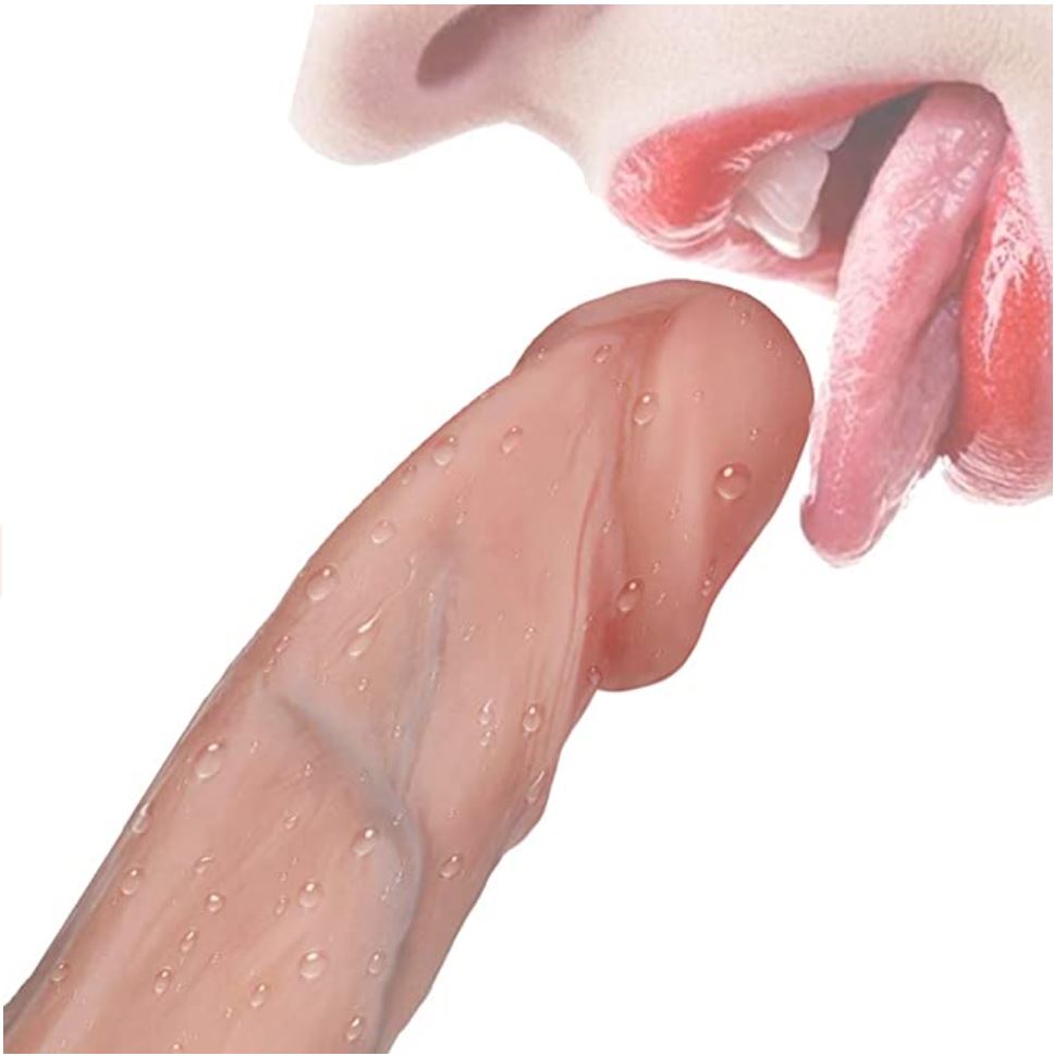 A person licking the tip of a realistic, flesh-toned silicone dildo covered in water droplets